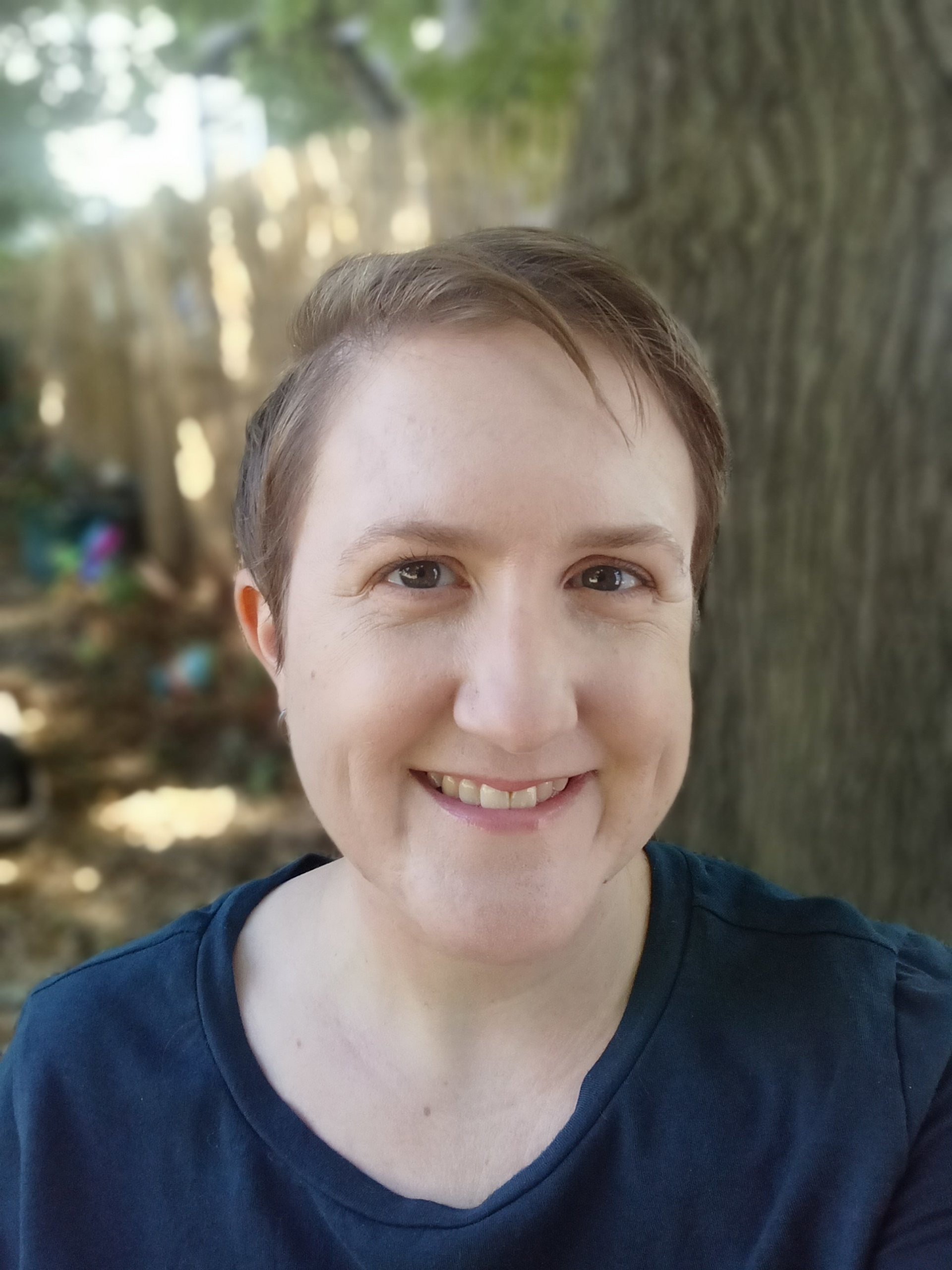 A close headshot of Alison, a woman with short hair and in a dark blue t-shirt.